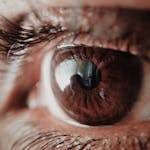 Detailed macro shot of a human eye capturing intricate details of the iris and reflections.